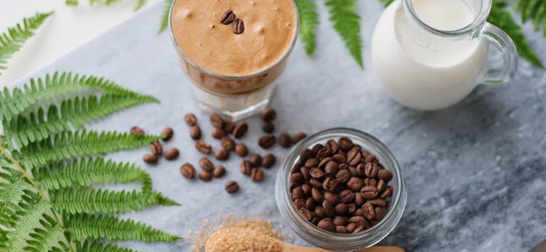 Coffee beans on table with milk and iced coffee